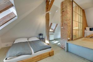 a bedroom with a bed and a brick wall at Stary Dom w Sopocie in Sopot