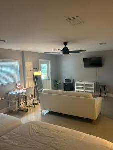 a living room with a white couch and a ceiling at Elles Place in Fort Lauderdale