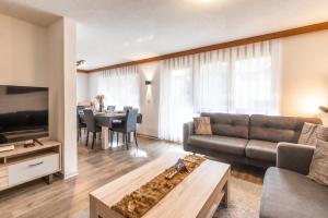 a living room with a couch and a table at Fabi`s Horu Lodge in Zermatt