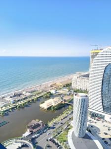 Una vista de un hotel y el océano. en Holiday Point Orbi City, en Batumi