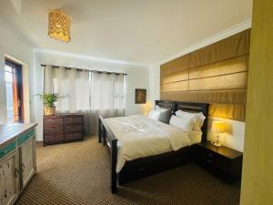 a bedroom with a large bed and a window at Clearwater view in Cape Town