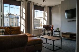 a living room with a couch and a coffee table at Town Centre 2 Bedroom Apartment in Lincolnshire