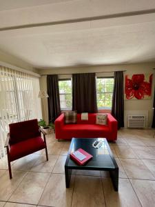 a living room with a red couch and a table at Beach Resort in Cape Coral in Cape Coral +49 photos