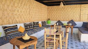 a room with a couch and chairs and a table at Hotel Riad Fantasia in Marrakesh