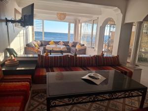 a living room with a couch and a table at Surfstay Taghazout 2 in Taghazout