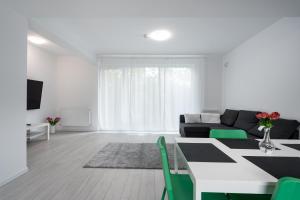a white living room with a table and a couch at Vila Magurele 3 in Măgurele