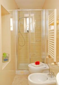 a bathroom with a shower and a toilet and a sink at Mario Suite Spagna in Rome