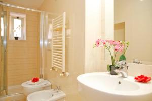 a bathroom with a sink and a toilet and a shower at Mario Suite Spagna in Rome +15 photos