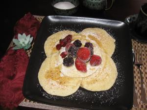 a plate of pancakes with fruit on top at Driftwood Heights B&B in Summerside