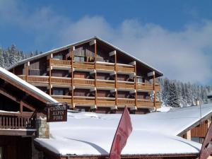 a large wooden building with a sign in the snow at Studio cabine Les Saisies, 4 pers, balcon sud, TV, proche pistes - FR-1-293-332 in Hauteluce