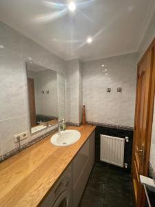a bathroom with a sink and a mirror at Apartamento de Toró in Llanes +16 photos
