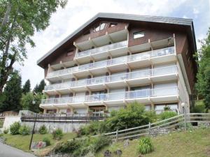 a large apartment building with a lot of windows at Studio lumineux avec parking et petits animaux acceptés - 4 personnes - FR-1-198-115 in Châtel +3 photos