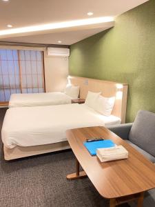 Postel nebo postele na pokoji v ubytování HIZ HOTEL Gion-Shirakawa