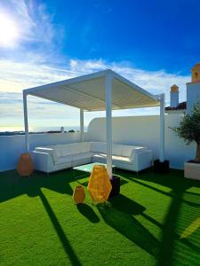 a gazebo sitting on top of a green lawn at Oceanview luxury Penthouse in Estepona