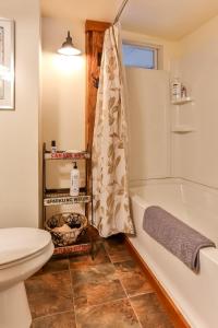 a bathroom with a white tub and a toilet at Majestic Mountain Retreat with Fire Pit Facing Mtn in Hunter +11 photos