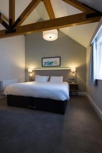a bedroom with a large bed in a room at Green Dragon, Welton by Marston's Inns in South Cave