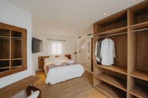 a bedroom with a bed and a tv in it at FERGUS Style Punta Arabi in Es Cana