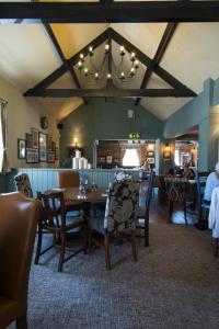 a dining room with a table and chairs at Green Dragon, Welton by Marston's Inns in South Cave