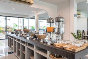 a counter with glasses on it in a room at Kokotel Pattaya North Beach in Pattaya North