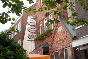 a brick building with signs on the side of it at Hotel Schmidt am Markt in Meppen