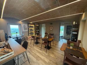 a restaurant with tables and chairs and a room with wine bottles at Country House Villa Barbero in Mango