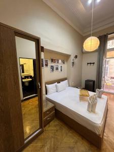 a bedroom with a large bed and a large mirror at paris east rooms in Cairo