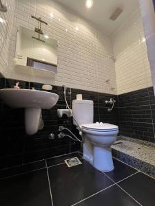 a bathroom with a white toilet and a sink at paris east rooms in Cairo