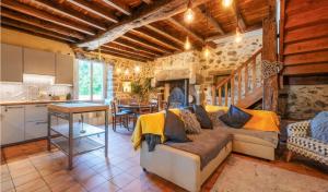a large living room with a couch and a kitchen at Moulin de Rochoux Gites - Puy du Fou in Saint-Clémentin
