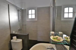 a bathroom with a toilet and a sink and a shower at Kini Bay in Kini +72 photos