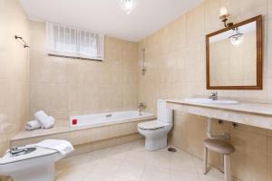 a bathroom with a toilet and a tub and a sink at 3BR Jandia House - Private Pool, Seaviews & Golf in Pájara +25 photos