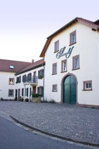 a large white building with a green door at Hotel Sonnenhof in Perl