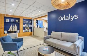 a waiting room with a couch and chairs in a office at Résidence Odalys Archipel in La Rochelle