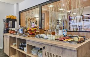 a buffet line with food on display in a store at Résidence Odalys Archipel in La Rochelle