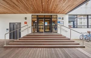 a staircase leading to a building with a wooden ceiling at Résidence Odalys Archipel in La Rochelle