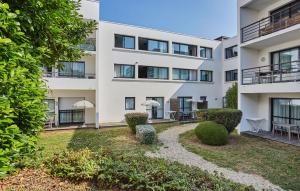 an apartment building with a garden in front of it at Résidence Odalys Archipel in La Rochelle