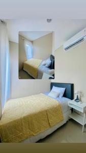 a bedroom with two beds and a mirror at Villa finna in Pasuruan +10 photos
