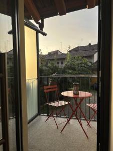 a balcony with a table and two chairs on a patio at Casa Emma Homestay in Alba city center in Alba