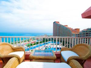 a balcony with chairs and a table and the ocean at Porto Sokhna Majestic in Ain Sokhna