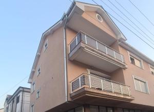 a building with a balcony on the side of it at Apartment Andrin in Gostivar