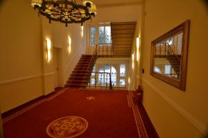 a hallway with a chandelier and stairs in a house at Seehotel Hubertus in Schluchsee