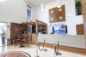 a restaurant lobby with a counter and a bar at Ville Hotel Gramadão in Votuporanga