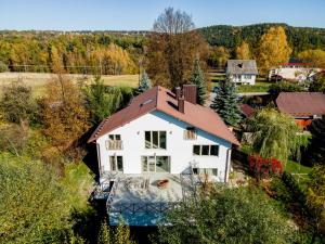 an aerial view of a white house with a brown roof at Dom pod Lipą in Łyczanka