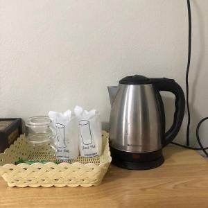a coffee pot and a basket on a table at Amantra Resort Satun in Ban Prok To Lem