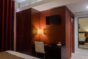 Uma TV ou centro de entretenimento em Hotel Torre Mar