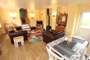 a living room with a couch and a table at Blaencwm Cottages in Boncath