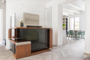a living room with a large entertainment center at La Terrazza su Dante Rooms in Palermo