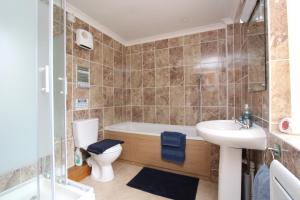 een badkamer met een bad, een toilet en een wastafel bij Blaencwm Cottages in Boncath +32 foto's