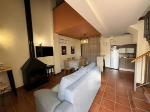 a living room with a couch and a fireplace at Casa Rural Rincón del Lago in El Ronquillo