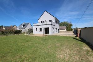 a white house with a yard in front of it at MAISON DE VACANCES 4 Clés - BORD DE MER DENNEVILLE PLAGE in Denneville