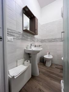 a white bathroom with a sink and a toilet at Nonna Concetta B&B Nocera - Vicino Tribunale di Nocera - Ristrutturato 2022 in Nocera Inferiore